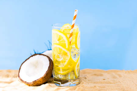 coconut and lemonade on sandy beach. Travel and beach vacation.