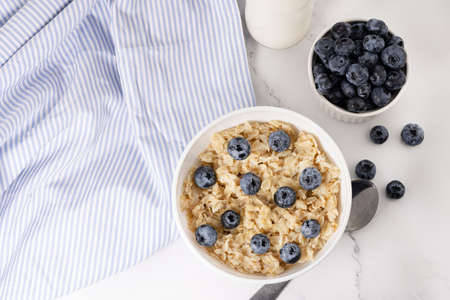 a bowl of oatmeal and blueberries. Healthy breakfast. Top view.の写真素材