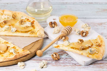 slice of pizza and blue cheese, caramelized pear and honey.の写真素材