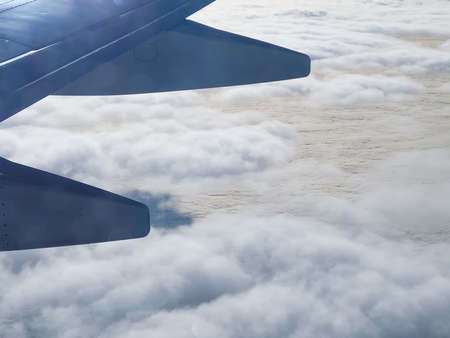 wing of an airplane flying above the blue sky clouds. Flight, travel.の写真素材