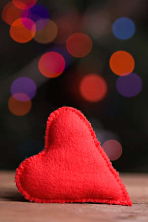 Handmade red textile heart on wood background. Valentin's day conceptの写真素材