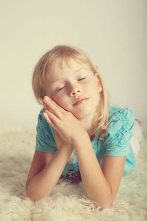  Beautiful girl dreaming lying on floorの写真素材