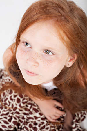 Close-up portrait of little redhead girl with green eyes の写真素材