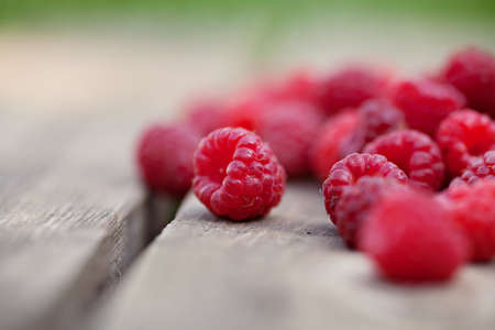 Rasperries fruit on wooden background outdoorの写真素材