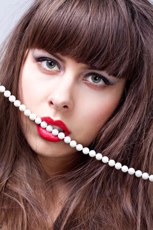 Woman with red lips and pearl necklaceの写真素材