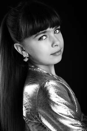 portrait of beautiful cute girl on black backgroundの写真素材