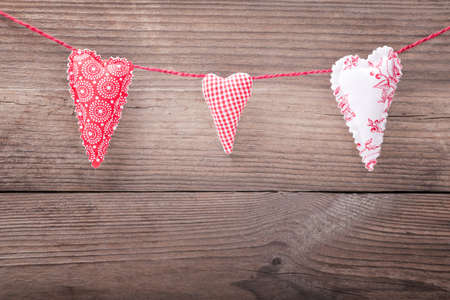 Three handmade hearts on wooden backgroundの写真素材