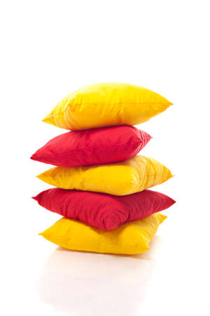 Stack of colorful pillows isolated over whiteの写真素材