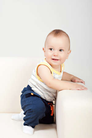 Baby boy sit on sofa
