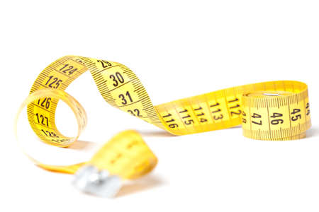 Yellow measuring tape isolated over white backgroundの写真素材