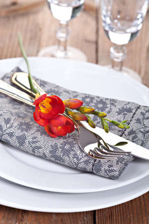  Closeup fork and knife with red fresia flowerの写真素材