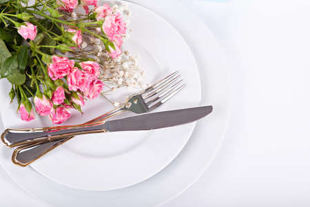 Closeup bouquet of small pink roses on plateの写真素材