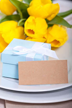 Blue gift box on plate with blank card for your textの写真素材