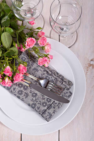 Festive table setting with roses の写真素材