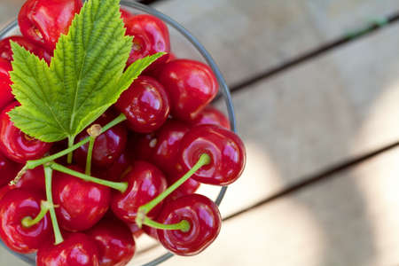 Sweet cherry fuits in bowl outdoorの写真素材