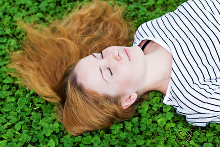 Girl relax on green grassの写真素材