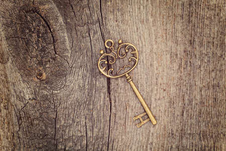 Vintage key on wooden backgroundの写真素材