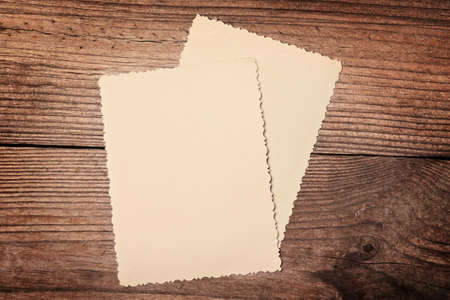 Bunch of old photos, back side on a top, on wooden backgroundの写真素材