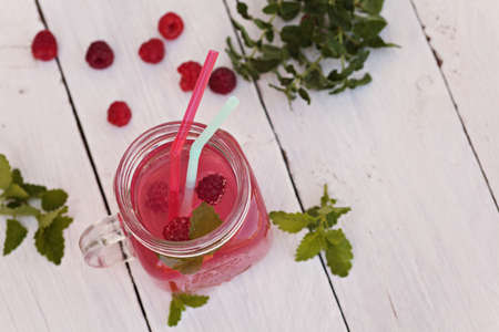 Cold raspberries drink in glass jar on white backgroundの写真素材