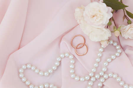 Wedding invitation card on pink silk background