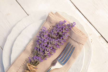 Served table set with lavender bunch on plateの写真素材