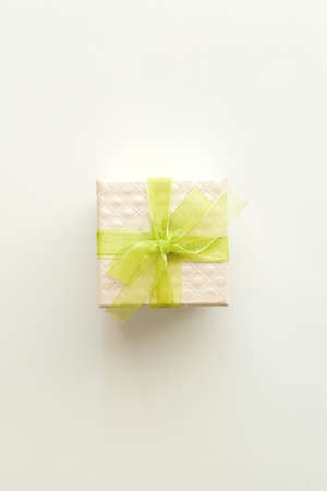Small gift box with green bow on white background