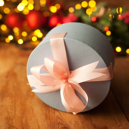 Christmas present box on light bokeh backgroundの写真素材