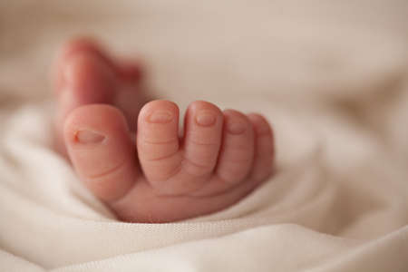 Close up baby tiny foots on white background