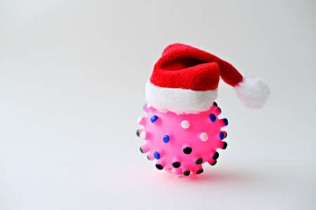 Coronavirus or Covid 19 concept design with toy ball in Santa's hat on white background の写真素材