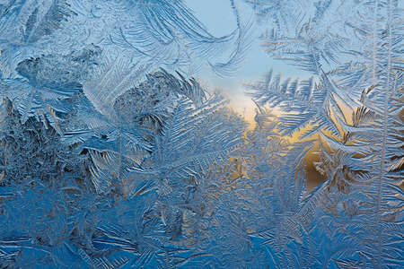 Beautiful natural frosty pattern on winter window.の写真素材