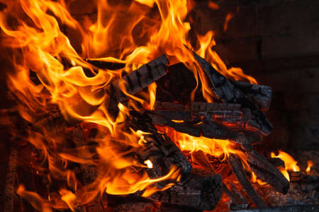 Fiery flame from burning wood in a fireplaceの写真素材