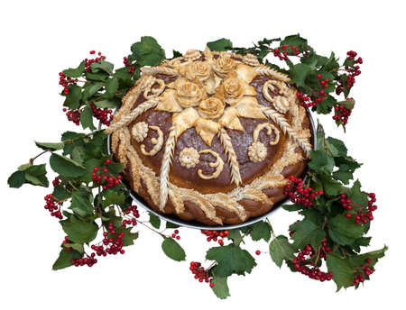 Traditional celebration Ukrainian loaf decorated with viburnumon a white backgroundの写真素材