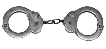 Isolated on white background handcuffs - metal rings connected by a chain, put on the hands of...