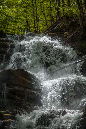Rapid waterfall among rocks in the Carpathian Mountainsの写真素材