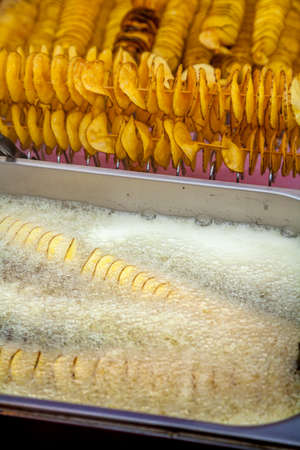 Potatoes sliced spitalyu fried in boiling fatの写真素材