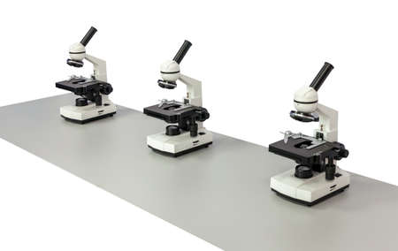 Several biological microscopes isolated on a white background