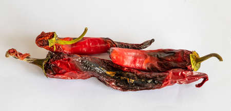Bad tainted chili pepper on a light backgroundの写真素材