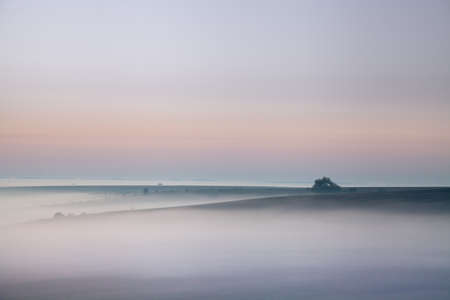 Morning sunrise over a misty valleyの写真素材