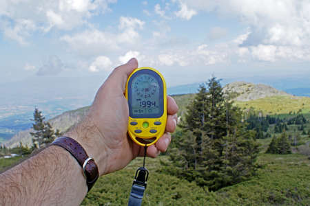 Altimeter, a device for determining the height above sea level, in the hand of a tourist during a...