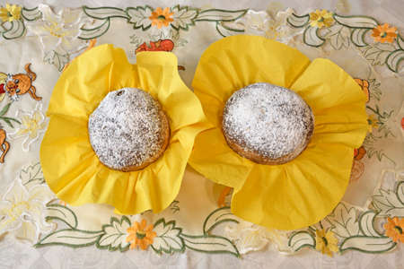 Two Easter cakes in yellow napkins.