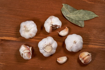Garlic and garlic cloves on wooden background.の写真素材