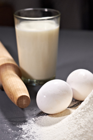 rolling pin, eggs, flour on grey backgroundの写真素材