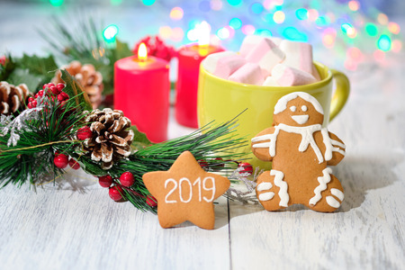 almond cookies and marshmallow on white background with Christmas tree ,  candles and christmas lightsの写真素材