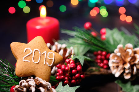 almond cookies and marshmallow on brown background with Christmas tree ,  candles and christmas lights. Close upの写真素材