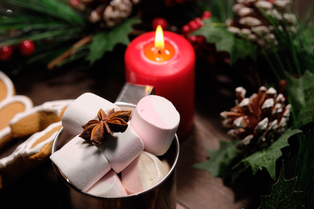 ginger biscuit and marshmallows in the iron cup on brown background with Christmas tree . Close upの写真素材