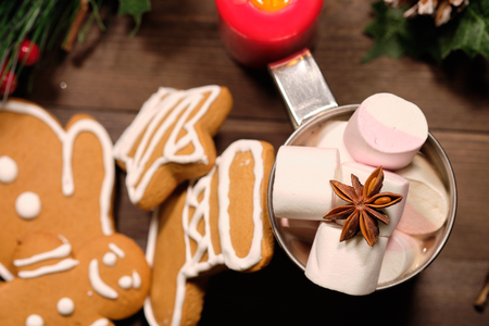 ginger biscuit and marshmallows in the iron cup on brown background with Christmas tree . Close upの写真素材