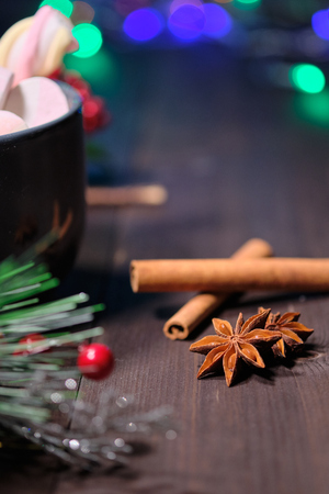 marshmallow in grey cup on brown wood background with Christmas tree ,  candles and christmas lights. Close upの写真素材