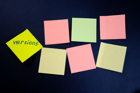 colored blank stickers and one separately on a dark blue background. Close upの写真素材