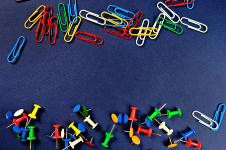 colored paper clips, button  on a dark blue background. Close upの写真素材
