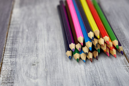 Colored pencils on grey wooden backgroundの写真素材